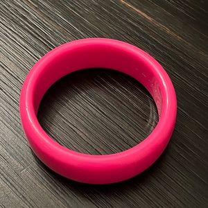 Hot pink plastic bangle.